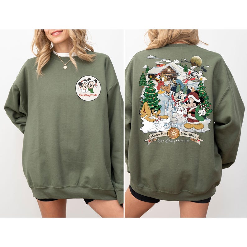 May include: A green sweatshirt with a Christmas scene featuring Mickey Mouse and friends on the back. The front of the sweatshirt has a small image of Mickey Mouse and Minnie Mouse with the text "Walt Disney World".
