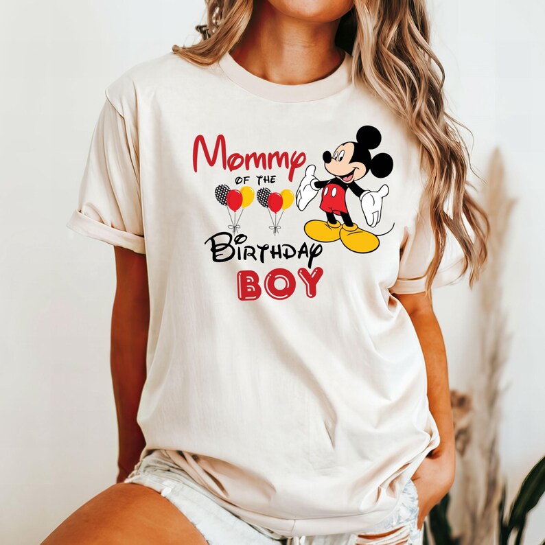 May include: A white t-shirt with the text "Mommy of the Birthday Boy" and a cartoon image of Mickey Mouse holding balloons.