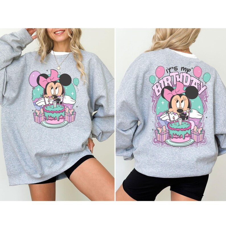 May include: A gray sweatshirt with a graphic of Minnie Mouse holding a birthday cake. The text "It's my Birthday" is printed on the back of the sweatshirt.