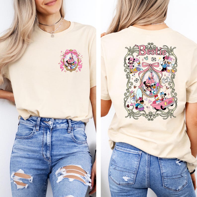 May include: A beige t-shirt with a pink and gold design featuring Mickey Mouse and Minnie Mouse on the front and a larger design on the back with the text "Bestie" and Mickey Mouse and Minnie Mouse characters in a car and other scenes.