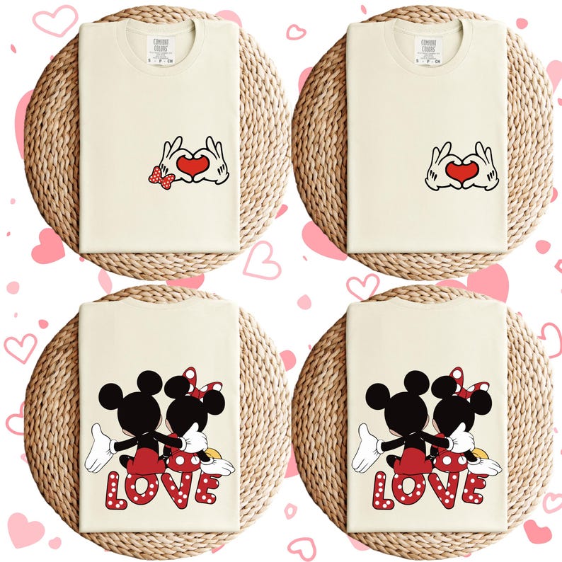 May include: Set of four cream-colored t-shirts with a Mickey Mouse and Minnie Mouse design. Two shirts feature Mickey and Minnie holding hands with a red heart in the middle. The other two shirts feature Mickey and Minnie holding hands with the word "LOVE" in red letters.