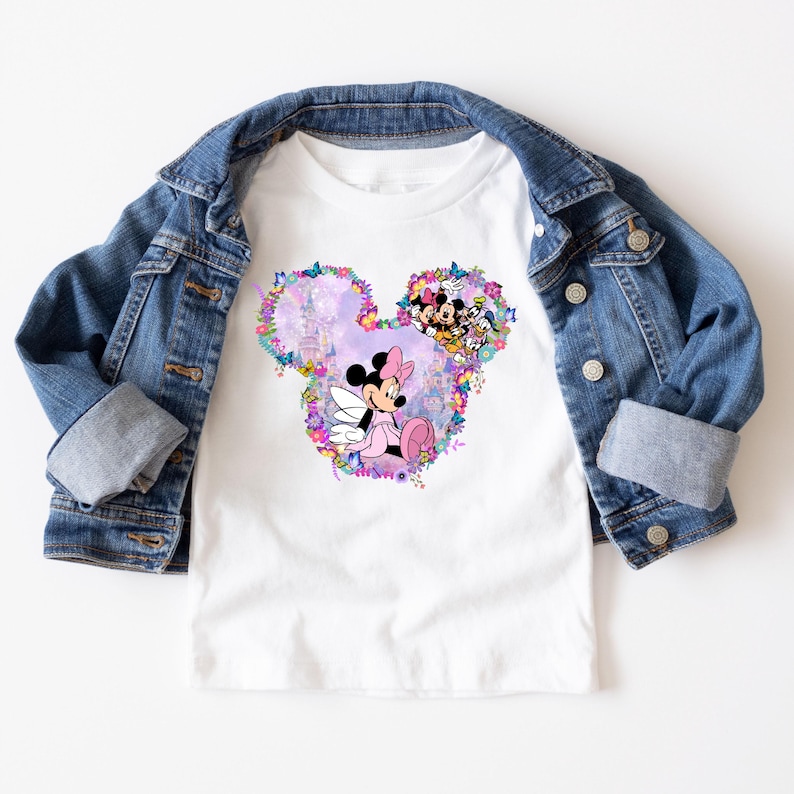 May include: White t-shirt with a pink and purple floral design featuring Mickey Mouse and Minnie Mouse. The design is in the shape of Mickey Mouse's head.