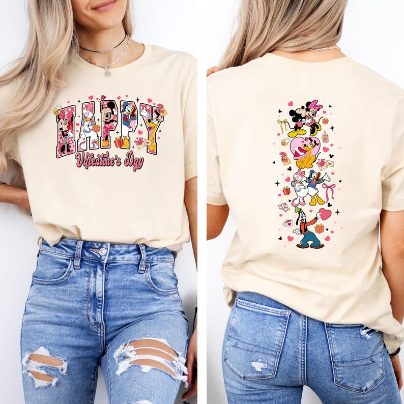 May include: A cream-colored t-shirt featuring the text "HAPPY Valentine's Day" in a colorful, cartoonish font. The front of the shirt has Disney characters incorporated into the letters. The back of the shirt has a vertical design of Disney characters.