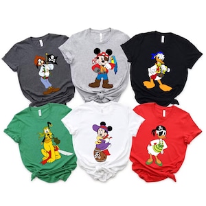 May include: A collection of six t-shirts featuring Disney characters in pirate attire. The shirts are in various colors, including gray, black, white, green, and red. Each shirt displays a different character, such as Mickey Mouse, Donald Duck, and Goofy.