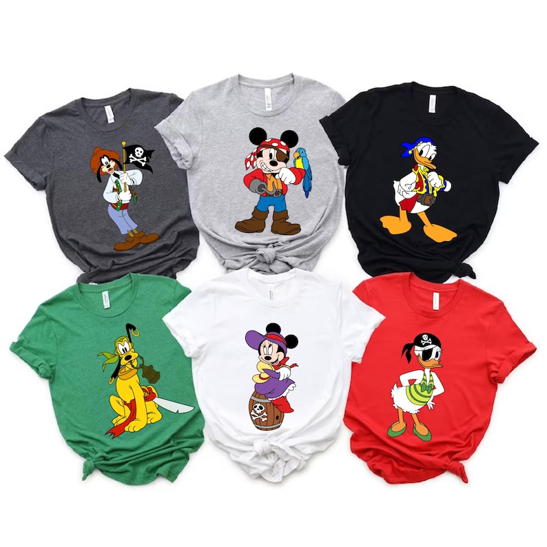 May include: A collection of six t-shirts featuring Disney characters in pirate attire. The shirts are in various colors, including gray, black, white, green, and red. Each shirt displays a different character, such as Mickey Mouse, Donald Duck, and Goofy.