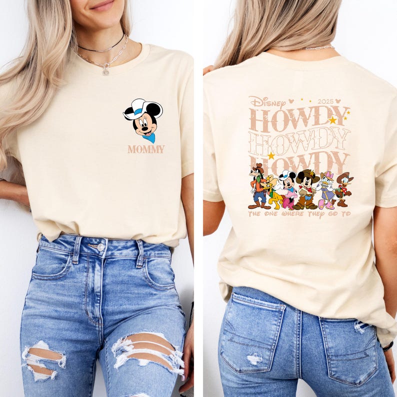 May include: A cream-colored t-shirt featuring a Mickey Mouse graphic with a cowboy hat and the word "MOMMY" in pink. The back of the shirt displays the text "HOWDY" repeated multiple times, along with Disney characters and the phrase "THE ONE WHERE THEY GO TO".