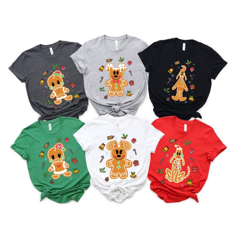 May include: Six different gingerbread-themed t-shirts in various colors, featuring gingerbread characters with candy cane accents. The shirts are all short-sleeved and crew neck.