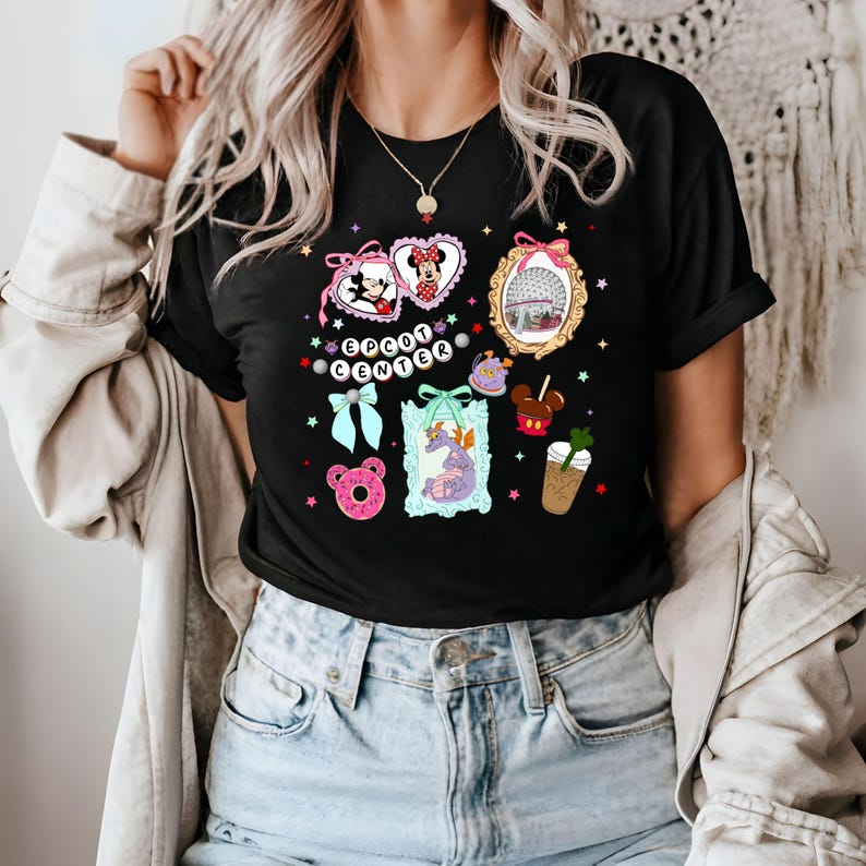 May include: Black t-shirt with a colorful graphic design featuring Mickey Mouse, Minnie Mouse, and other Disney characters. The graphic includes the text "EPCOT CENTER".