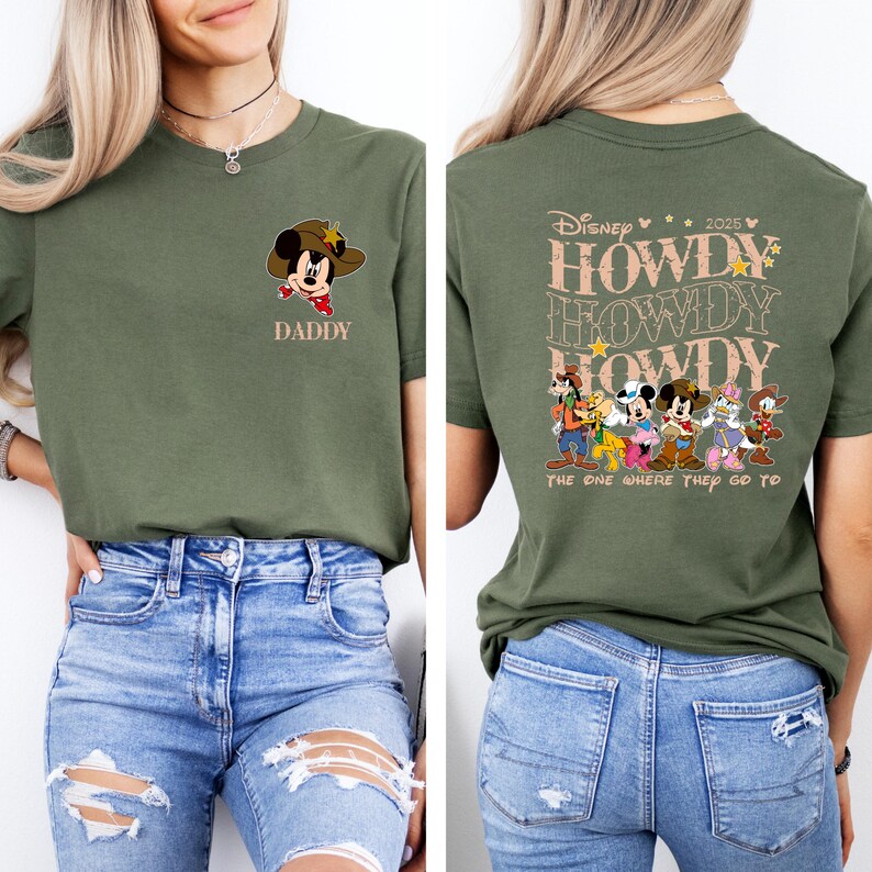 May include: Olive green t-shirt featuring a Mickey Mouse cowboy graphic with the word "DADDY" below it. The back of the shirt displays "Disney 2025" and the word "HOWDY" repeated three times, along with a group of Disney characters.