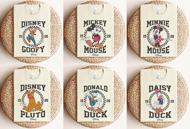 May include: Six beige t-shirts with a vintage-style Disney character graphic on each. The characters are Goofy, Mickey Mouse, Minnie Mouse, Pluto, Donald Duck, and Daisy Duck. Each graphic features a checkered background and the character's name in a bold font.
