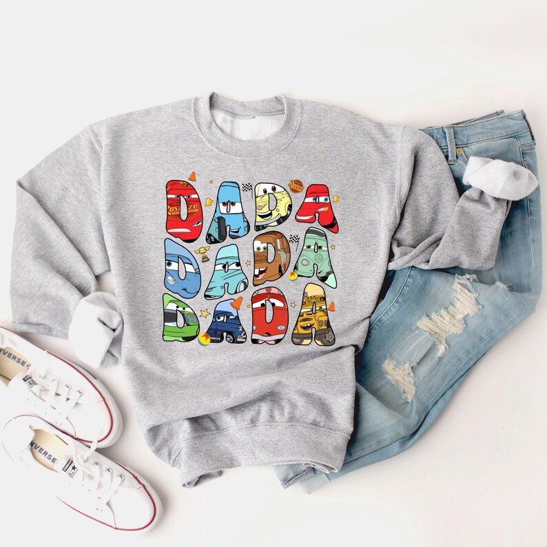 May include: Gray sweatshirt with a graphic of cartoon cars spelling out "DADA" in colorful letters.