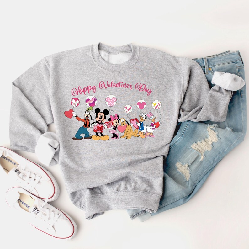 May include: Gray sweatshirt with a pink "Happy Valentine's Day" graphic featuring Mickey Mouse, Minnie Mouse, Goofy, Pluto, and Donald Duck holding hearts and balloons.