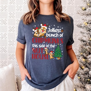May include: A navy blue t-shirt with a Christmas-themed design featuring Chipmunks from the movie "Alvin and the Chipmunks". The design includes the text "Jolliest bunch of Chipmunks this side of the Nut House".