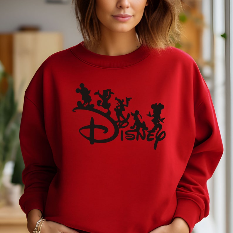 May include: Red sweatshirt with a black graphic of Mickey Mouse and other Disney characters with the word "Disney" in a stylized font.