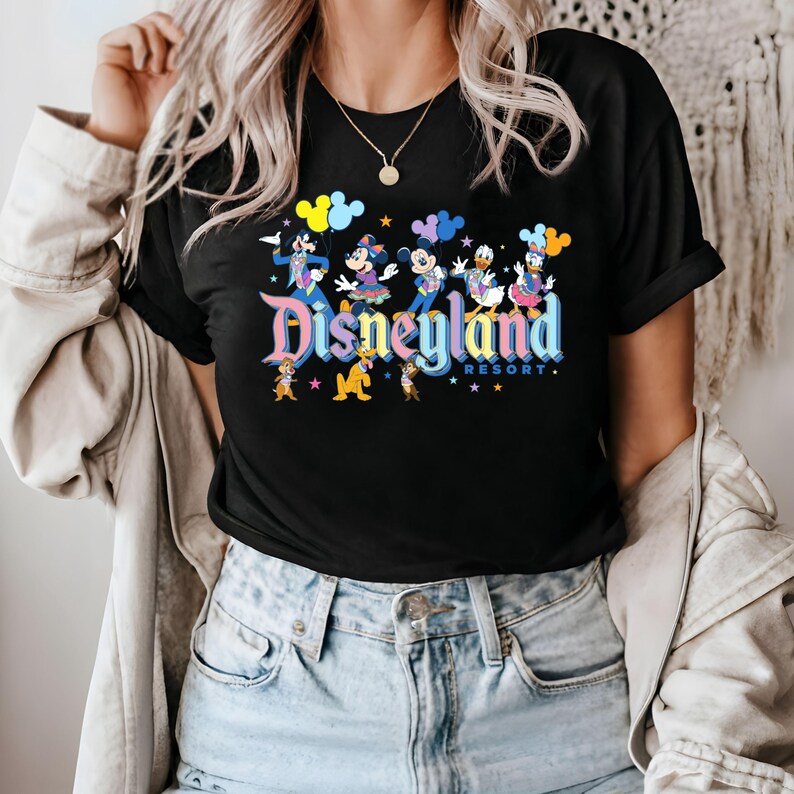 May include: Black t-shirt featuring a colourful Disneyland Resort graphic with Mickey Mouse, Minnie Mouse, Donald Duck, Goofy and Pluto. The graphic includes the text "Disneyland Resort" in a rainbow font.