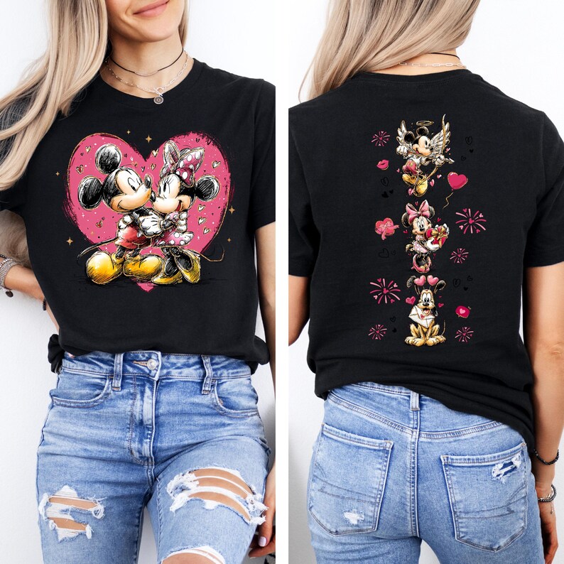 May include: Black t-shirt featuring Mickey and Minnie Mouse kissing inside a pink heart. The back of the shirt displays Mickey, Minnie, and Pluto with Valentine's Day graphics. The shirt is worn by a person.