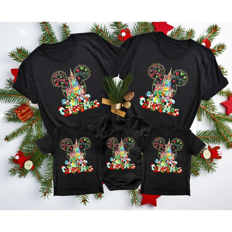 May include: A set of four black t-shirts featuring a Mickey Mouse head with a Christmas-themed design of the Disney World castle and characters. The shirts are in different sizes for adults and children.