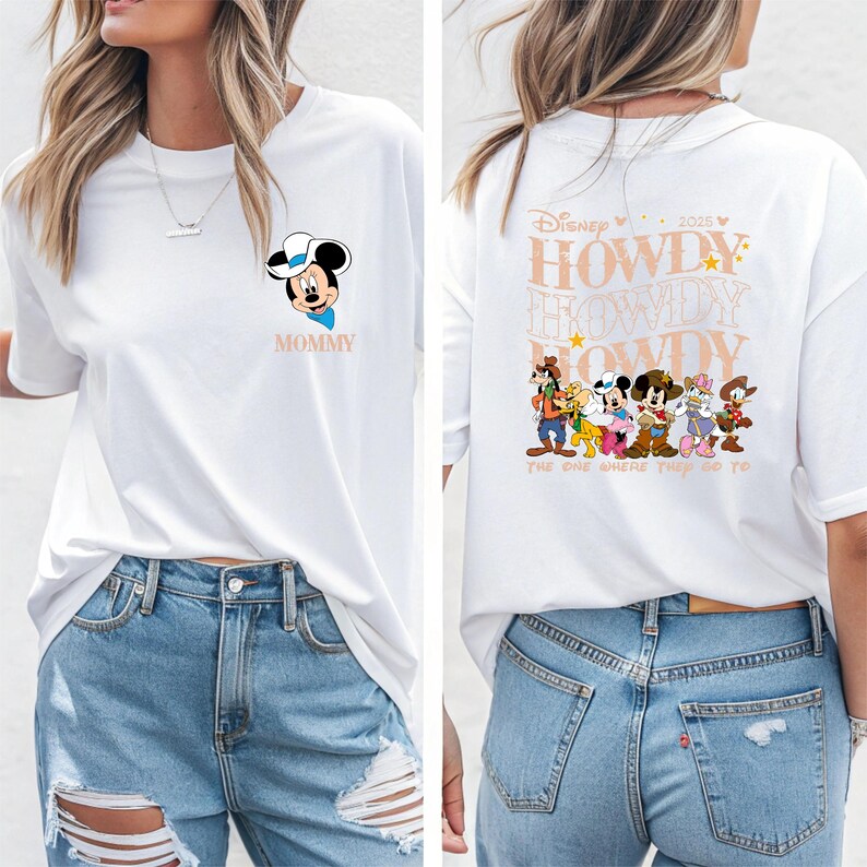 May include: White t-shirt featuring Mickey Mouse in a cowboy hat with the word "MOMMY" below. The back of the shirt has the text "HOWDY" repeated with Disney characters and the phrase "THE ONE WHERE THEY GO TO".
