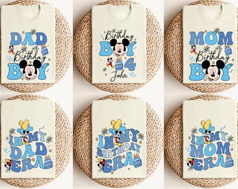 May include: Six white t-shirts with blue and yellow Mickey Mouse birthday designs. The shirts feature the text "Dad of the Birthday Boy", "Mom of the Birthday Boy", "In My Dad Era", "In My Birthday Era", and "In My Mom Era". One shirt has the text "Birthday Boy 4 John".
