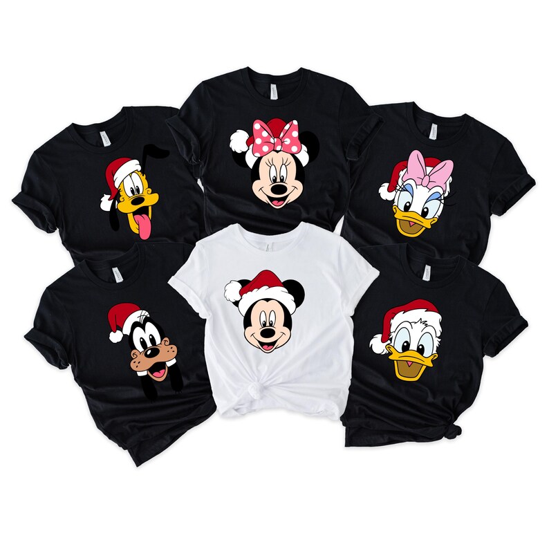May include: Six black and white t-shirts with different Disney characters wearing Santa hats. The characters are Mickey Mouse, Minnie Mouse, Goofy, and Donald Duck.