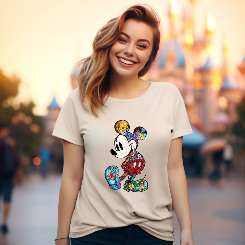 May include: A beige t-shirt with a colorful Mickey Mouse graphic. The graphic is made up of different Disney characters and icons.