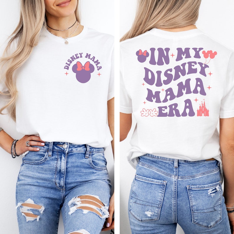 May include: White t-shirt with a purple Mickey Mouse head with a pink bow on the front and the text "Disney Mama" in purple. The back of the shirt has the text "In My Disney Mama Era" in purple with a pink castle and Mickey Mouse hands.