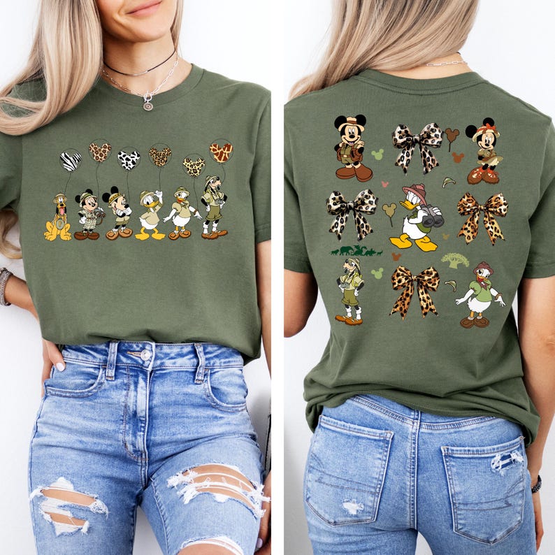 May include: A green t-shirt with a safari-themed design featuring Mickey Mouse and Donald Duck characters. The front of the shirt shows the characters holding balloons with animal print designs. The back of the shirt features the characters with bows and other safari-themed elements.