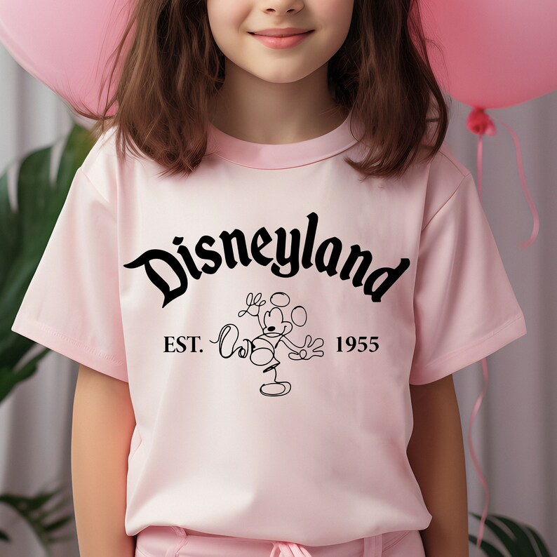 May include: Pink t-shirt with a black graphic of Mickey Mouse and the text "Disneyland Est. 1955".