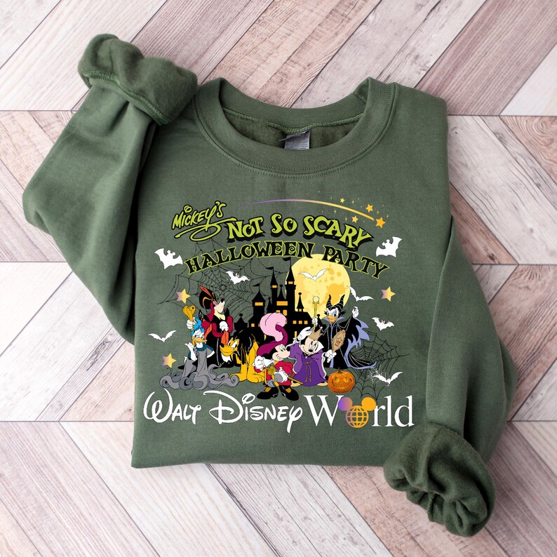 May include: Green sweatshirt with a Mickey's Not So Scary Halloween Party design. The design features Mickey Mouse and friends dressed in Halloween costumes. The text "Walt Disney World" is printed below the design.
