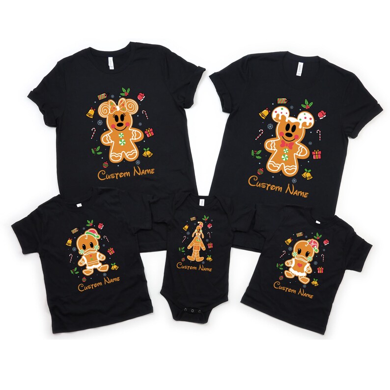 May include: A set of four black t-shirts featuring a gingerbread man design with the text "Custom Name". The shirts are in different sizes for adults and children.