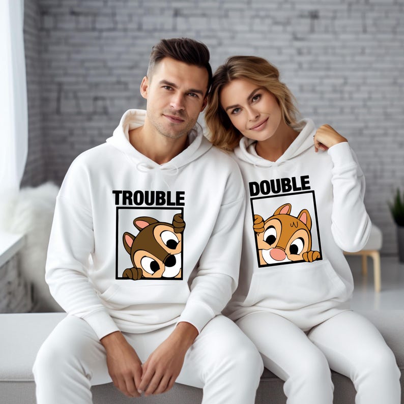 May include: A white hoodie with the text "Trouble" and a cartoon chipmunk peeking out of a box. A second white hoodie with the text "Double" and a cartoon chipmunk peeking out of a box.