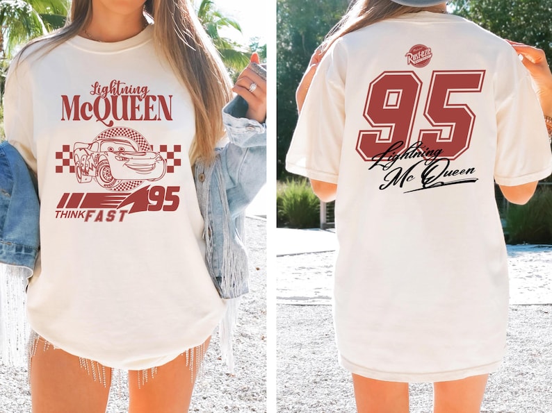 May include: White t-shirt with a red graphic of Lightning McQueen from Cars. The graphic includes the text "Lightning McQueen", "Think Fast", and the number "95". The back of the shirt has a red number "95" with the text "Lightning McQueen" in a cursive font.
