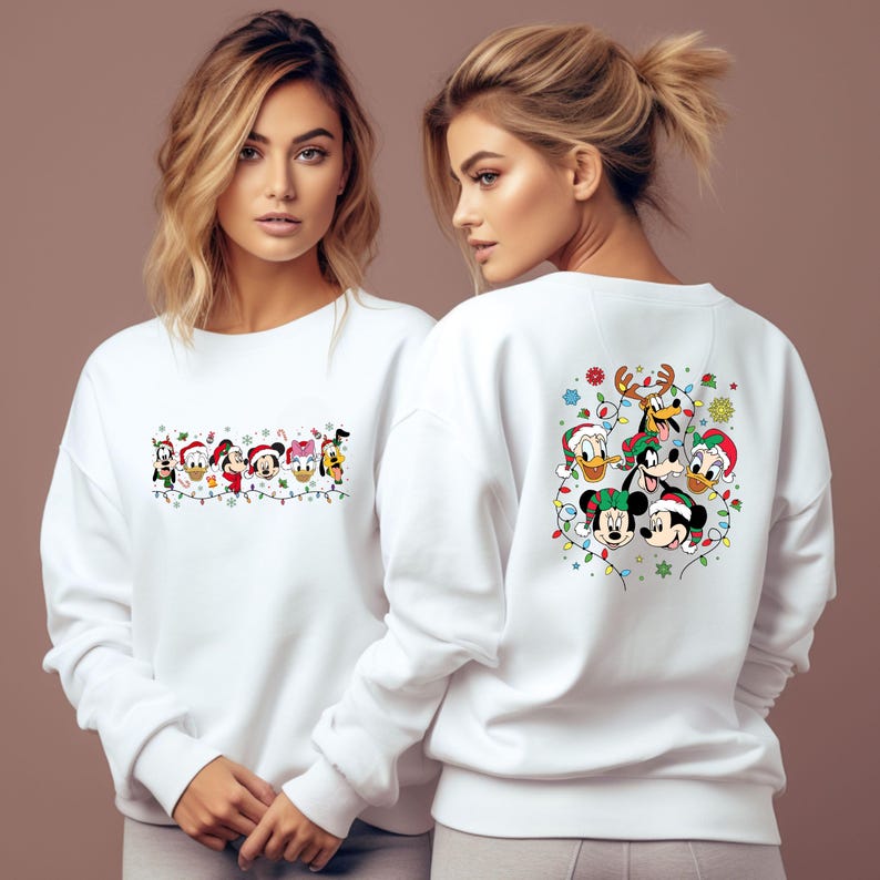 May include: White sweatshirt featuring a festive design with cartoon characters. The front displays a string of characters with Christmas lights, while the back showcases a group of characters in Santa hats and festive decorations. A cozy and cheerful holiday apparel.