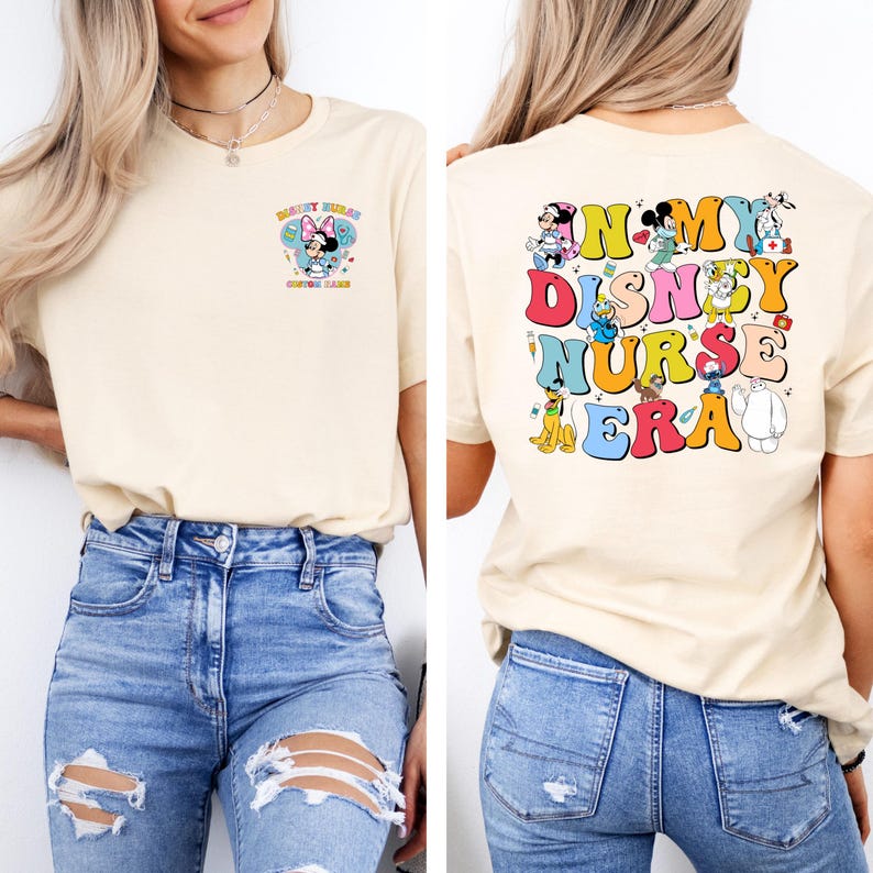 May include: Cream-colored t-shirt with a colorful graphic on the front and back. The front features a Minnie Mouse design with text. The back of the shirt says "In My Disney Nurse Era" with various Disney characters.