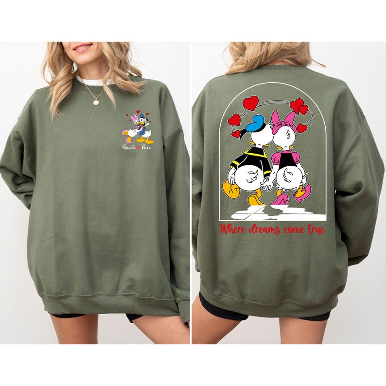May include: A green sweatshirt with a cartoon image of Donald Duck and Daisy Duck on the back. The text "Where dreams come true" is printed below the image. The front of the sweatshirt has a smaller image of Donald Duck and Daisy Duck with the text "Sequoia + Rex".