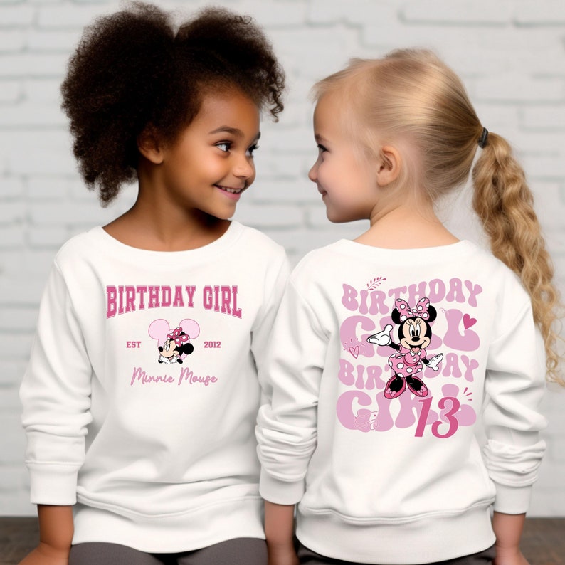 May include: Two white long-sleeved shirts with pink Minnie Mouse graphics. One shirt says "Birthday Girl" with Minnie Mouse and "Est. 2012 Minnie Mouse". The other shirt says "Birthday Girl Birthday Girl 13" with Minnie Mouse.
