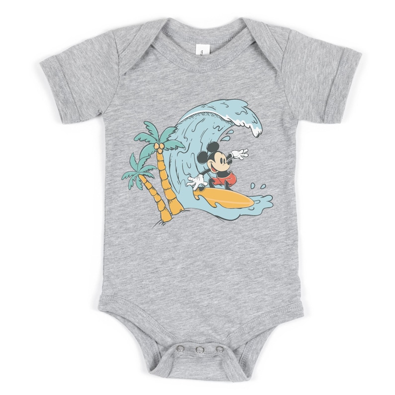 May include: A grey short-sleeved baby bodysuit with a graphic of Mickey Mouse surfing on a wave with palm trees in the background.