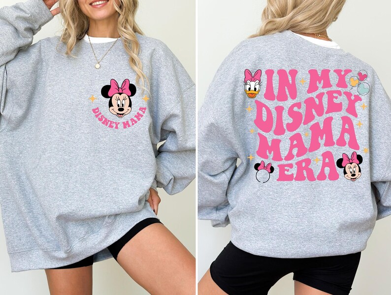 May include: Grey sweatshirt with a pink Minnie Mouse graphic on the front and the text "In My Disney Mama Era" in pink on the back. The sweatshirt has a crew neck and long sleeves.
