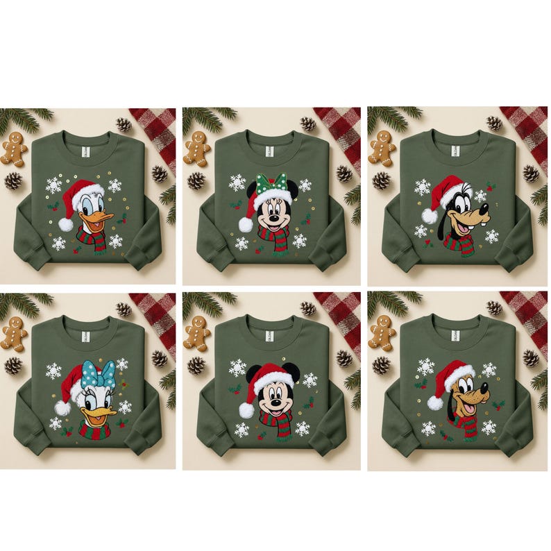 May include: Six olive green Christmas sweatshirts featuring Disney characters: Donald Duck, Minnie Mouse, Goofy, Daisy Duck, Mickey Mouse, and Pluto. Each sweatshirt has a character wearing a Santa hat and scarf, with snowflakes.