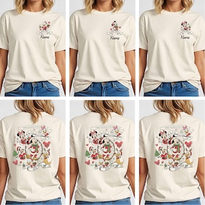 May include: Cream-colored t-shirt featuring a Mickey Mouse Christmas design. The front has a small graphic with Mickey and the text "2023 Party" and "Name". The back displays a larger festive scene with Mickey, Minnie, and friends, with the text "Mickey's Very Merry Christmas".