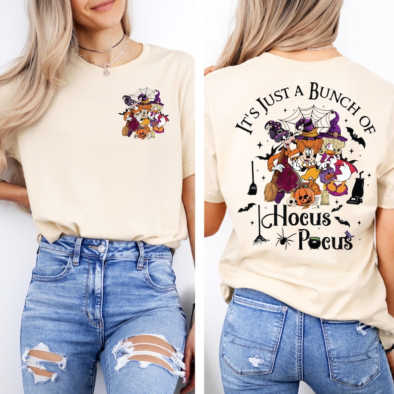 May include: A cream colored t-shirt with a graphic of a group of cartoon witches on the front and the text "It's just a bunch of Hocus Pocus" on the back.