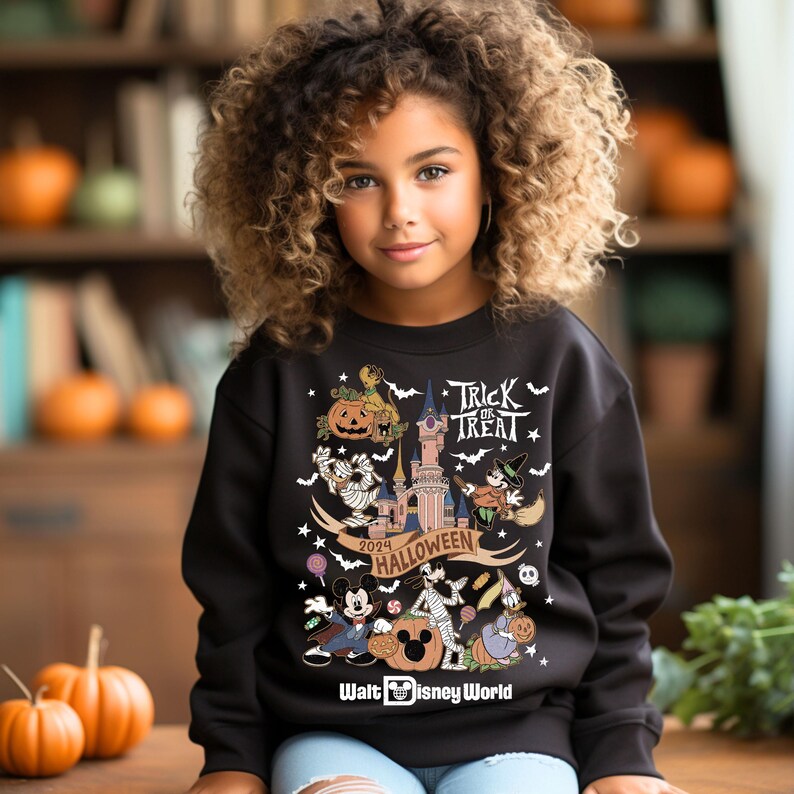 May include: Black sweatshirt with a colorful Halloween design featuring Mickey Mouse, Goofy, and other Disney characters. The design includes the text "Trick or Treat", "2024 Halloween", and "Walt Disney World".