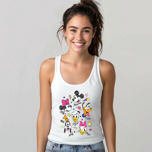 May include: White tank top with a colorful cartoon print of Mickey Mouse, Minnie Mouse, Donald Duck, Goofy, and Pluto. The characters are drawn in a doodle style with stars and hearts around them.