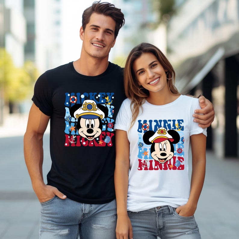 May include: A couple wearing matching black and white t-shirts with a nautical theme. The shirts feature Mickey Mouse and Minnie Mouse dressed as captains with the text "Mickey Mouse" and "Minnie Mouse" on the shirts.
