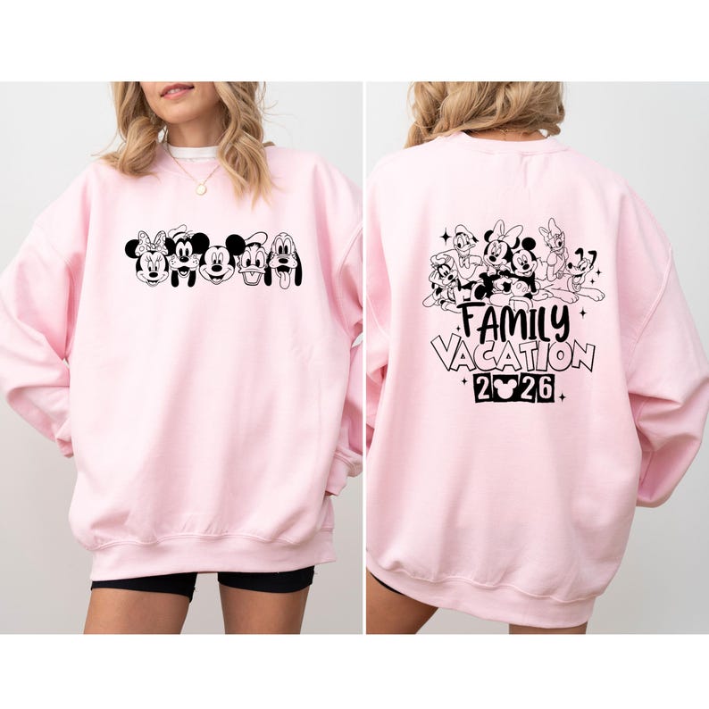 May include: A light pink sweatshirt featuring a black and white graphic of Disney characters on the front and back. The front graphic includes Minnie Mouse, Mickey Mouse, Donald Duck, and Goofy. The back graphic says "Family Vacation 2026."