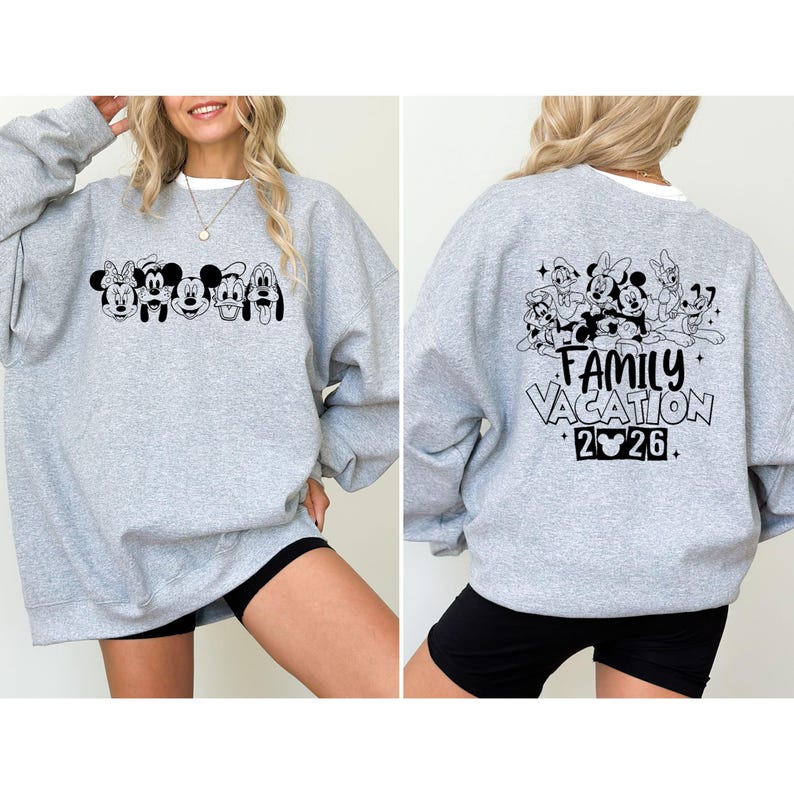 May include: A light gray sweatshirt featuring a black graphic of Disney characters on the front and back. The front graphic includes Minnie Mouse, Mickey Mouse, and Pluto. The back graphic says "Family Vacation 2026."