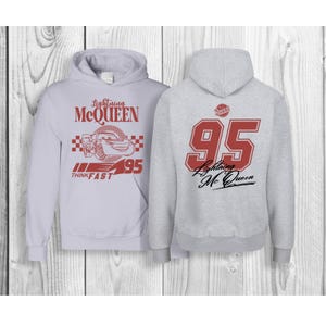 May include: Gray hooded sweatshirt with a red and white Lightning McQueen design on the front and a red number 95 with the text "Lightning McQueen" on the back.