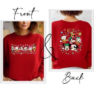 May include: Red sweatshirt featuring a festive design with Disney characters, including Mickey Mouse, Minnie Mouse, Donald Duck, and Goofy, adorned with Christmas lights and Santa hats. The back of the sweatshirt also displays a similar design. The word "Front" and "Back" are written on the image.