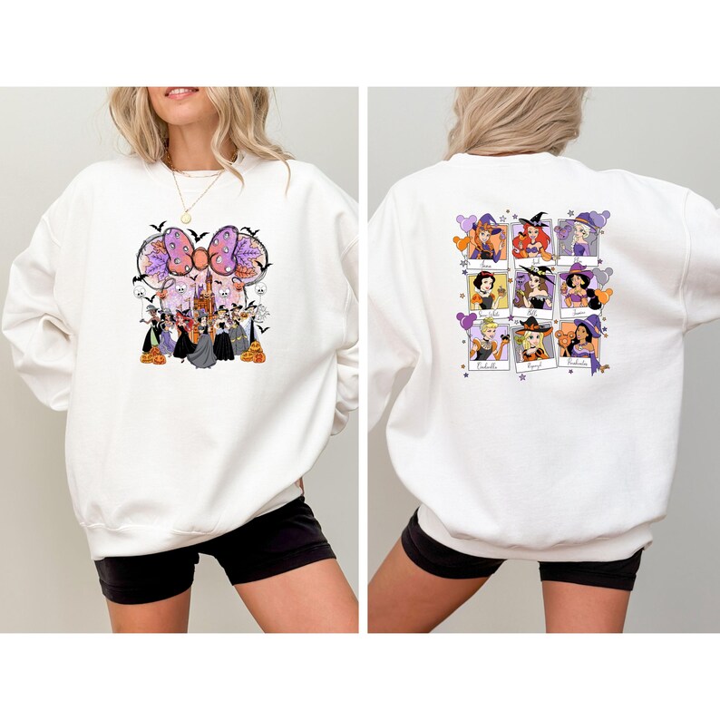 May include: White sweatshirt featuring a Halloween-themed graphic on the front and back. The front design includes a large bow, bats, and characters. The back displays nine framed images of characters with witch hats and balloons. A festive and fun design.