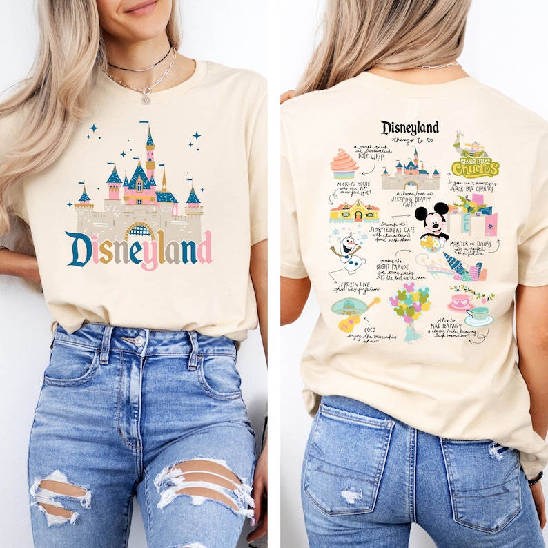 May include: A beige t-shirt with a graphic of the Disneyland castle on the front and a list of things to do at Disneyland on the back. The text on the back includes "Disneyland", "Things to Do", "Mickey's House", "Sleeping Beauty", "Jungle Cruise", "Haunted Mansion", "Peter Pan", "It's a Small World", "Coco", "Mad Tea Party", "Churros", "Storytellers Cafe", "Minnie & Daisy", "Pixie Hollow", "Night Parade", "The Disneyland Railroad", "and more!"
